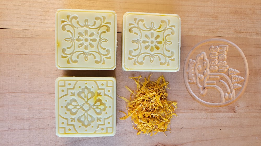 Serenity Calendula smaller bars with dried calendula petals on Fresh Suds board