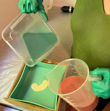 Colored soap being poured by hand into a mold in the Fresh Suds Chilliwack studio