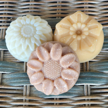 Comfort & Renewal Bars - 3 colourful, flower shaped soap bars on a wicker background - Fresh Suds Soapery