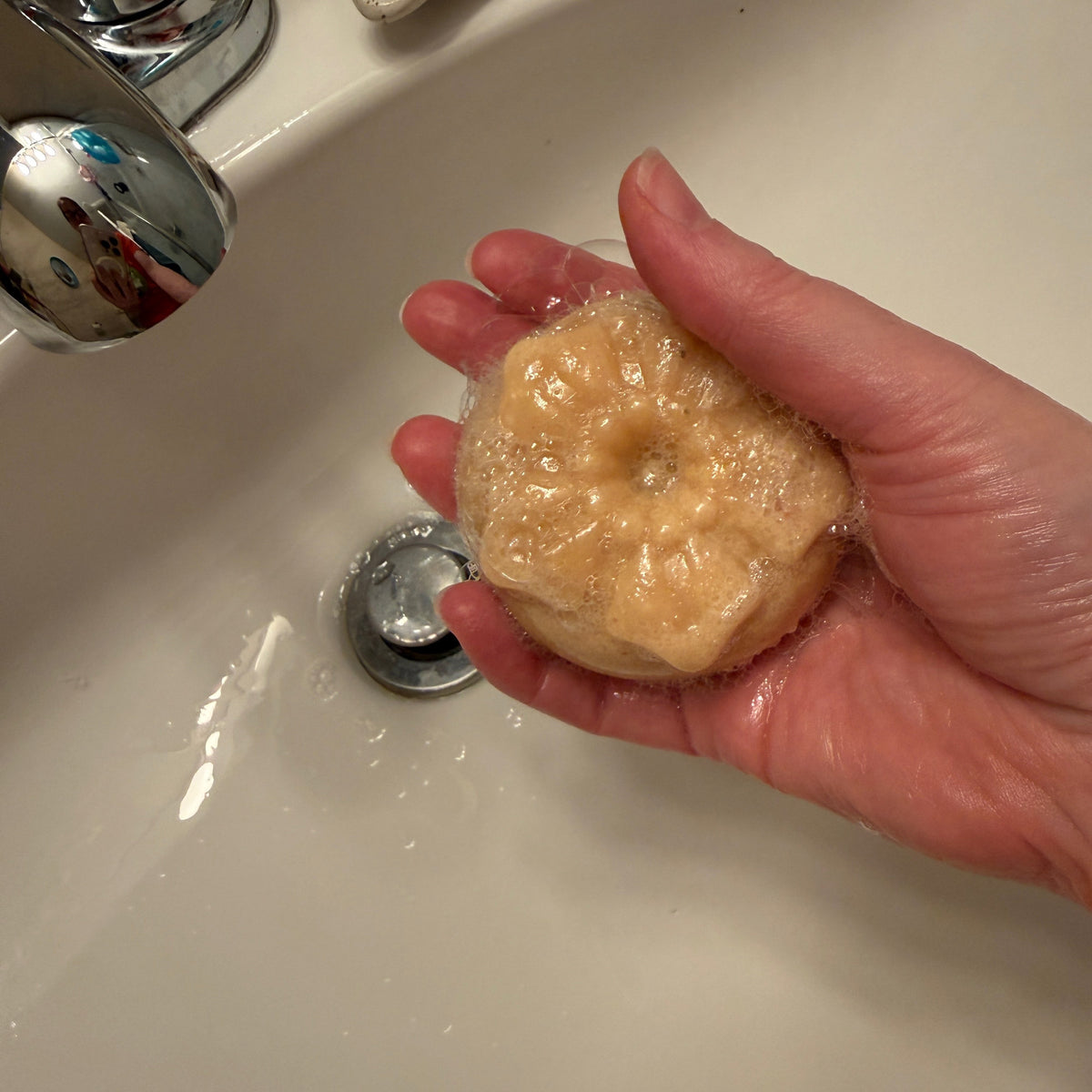 Lather from an Arctic Breeze salt soap bar in hand, real product photo