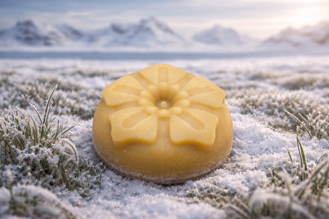 Yellow flower-shaped object on a snowy landscape with mountains in the background