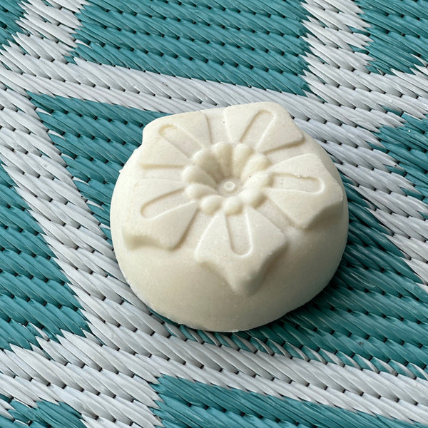 French sea salt soap bar on weathered wood, flecked with grey sea salt