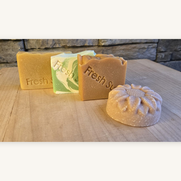 Four Fresh Favourites soap bars on a wooden board