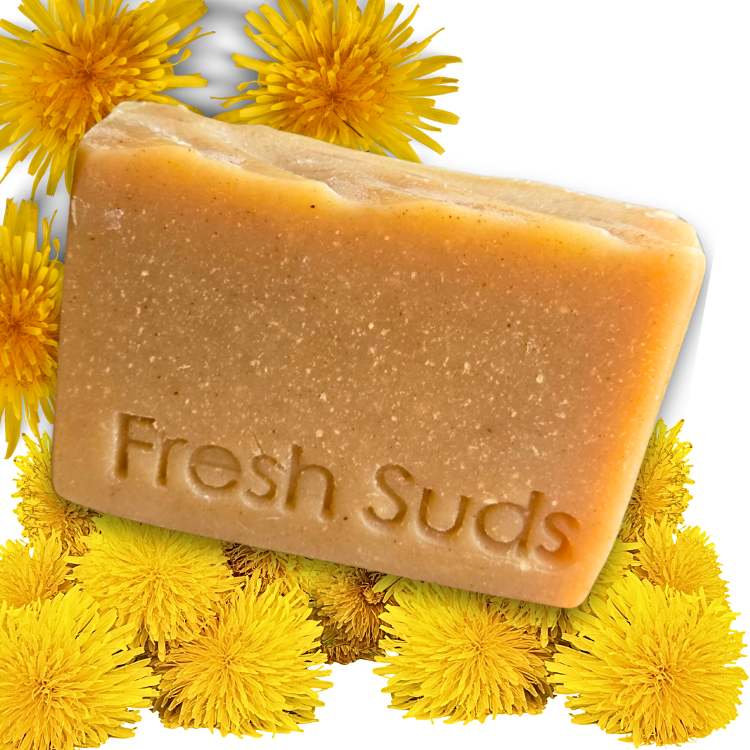 Restore Soap - Yellow soap bar on top of dandelions. - Fresh Suds Soapery