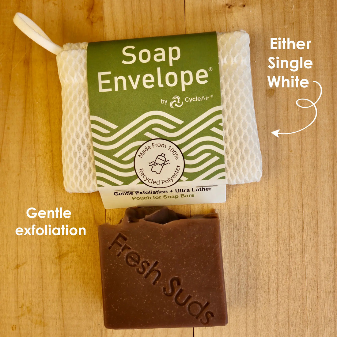 Soap Saver Duo: a hand holds a white Soap Envelope above a peach and pink swirled Fresh Suds bar on a wooden board