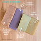 Four bars of soap with labeled scents on a wooden surface