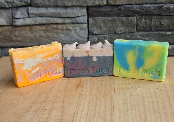 Slice of Summer bundle: Candy Floss, Picnic, and Golden Plumeria — three handmade Fresh Suds soap bars side by side on wood, made by hand in BC.