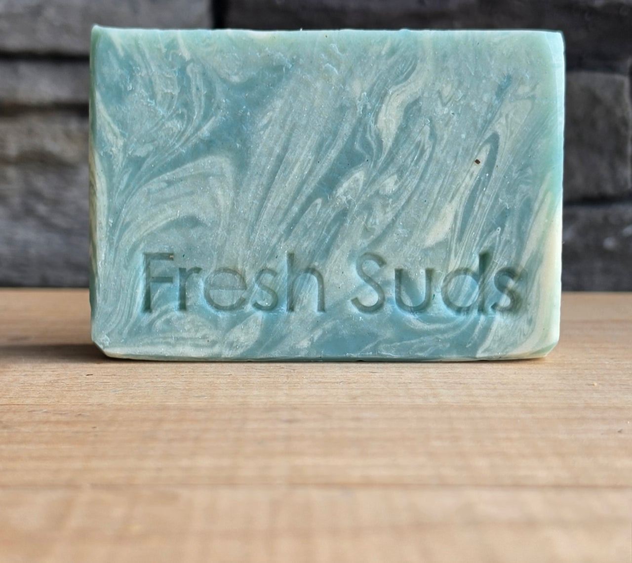 True North soap bundle on a wood table with the Glacier bar